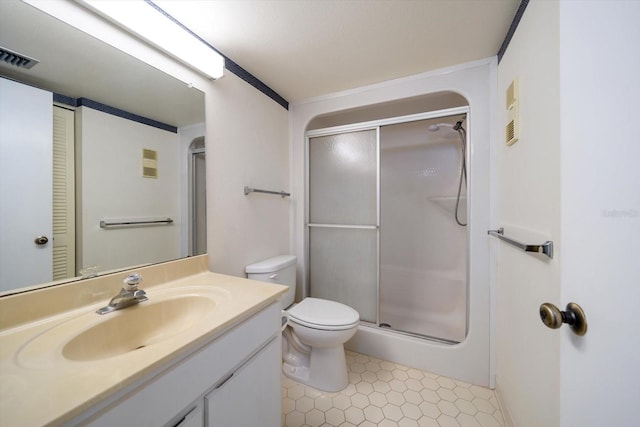 bathroom featuring an enclosed shower, vanity, tile patterned floors, and toilet