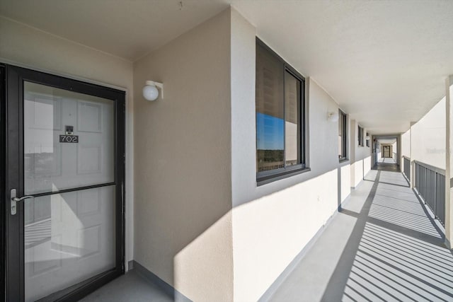 view of exterior entry with a balcony