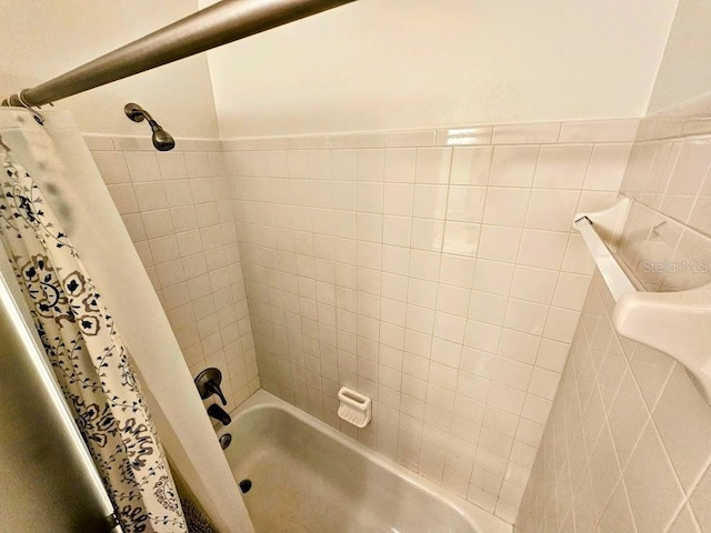 bathroom with shower / bath combination with curtain