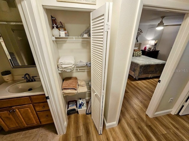 bathroom with vanity, hardwood / wood-style floors, and ceiling fan