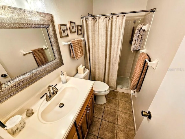 bathroom with a shower with curtain, tile patterned floors, vanity, and toilet