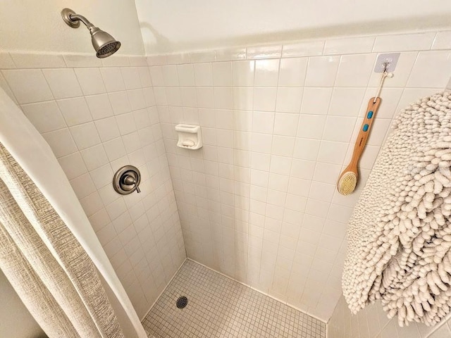 bathroom with tiled shower