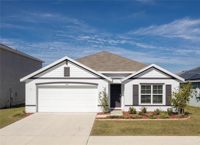 view of front of property featuring a garage and a front lawn