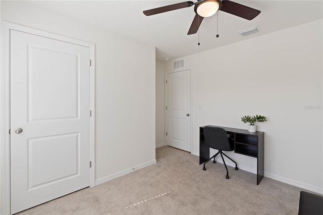 home office with light carpet and ceiling fan