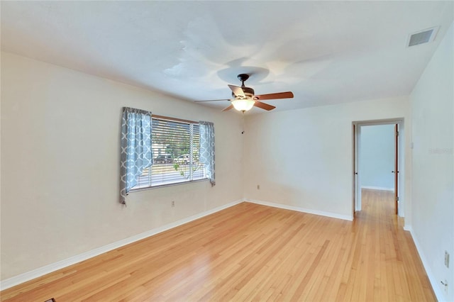 empty room with ceiling fan and light wood-type flooring