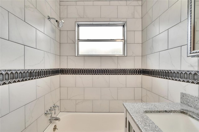 bathroom featuring vanity and tiled shower / bath combo