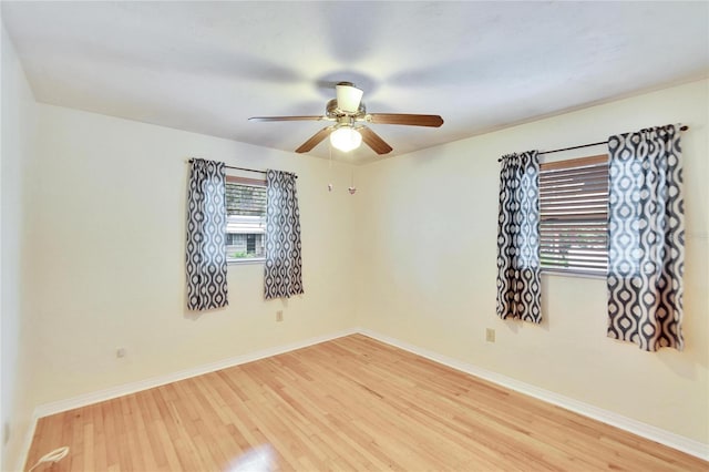 spare room featuring light hardwood / wood-style flooring and ceiling fan