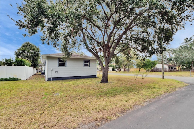 view of property exterior with a lawn