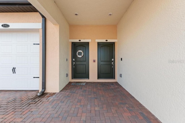 view of exterior entry with a garage