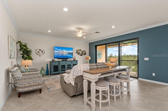 living room with ornamental molding, light tile patterned floors, and ceiling fan