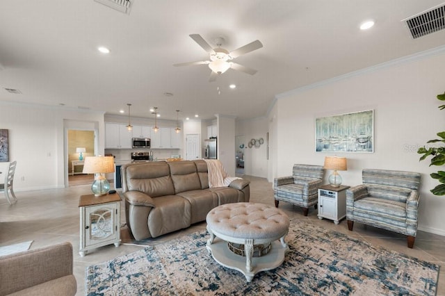 tiled living room with ornamental molding and ceiling fan