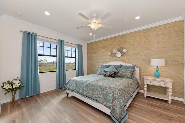 bedroom featuring crown molding, ceiling fan, and hardwood / wood-style floors