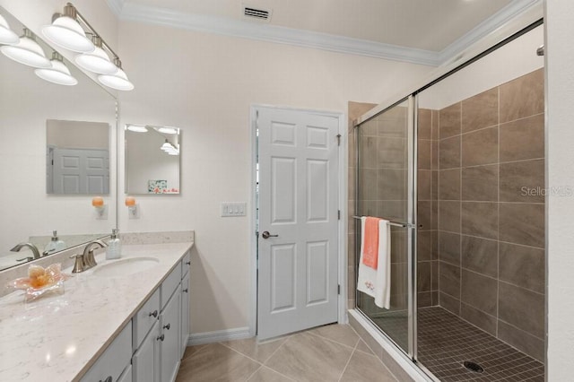 bathroom featuring crown molding, vanity, a shower with door, and tile patterned flooring