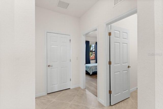 corridor with light tile patterned flooring