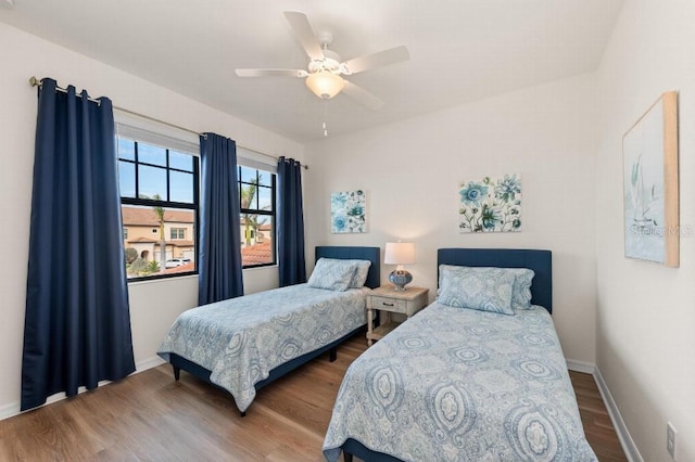 bedroom with hardwood / wood-style floors and ceiling fan