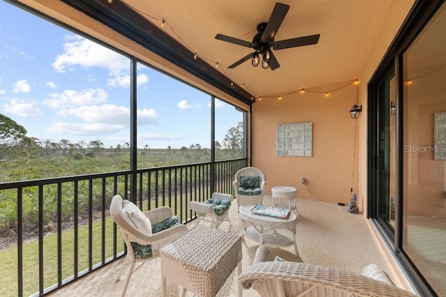 sunroom featuring ceiling fan and a wealth of natural light