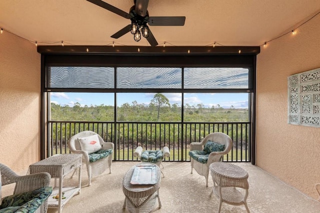 sunroom featuring ceiling fan