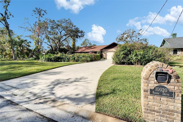 view of front of house with a garage and a front yard