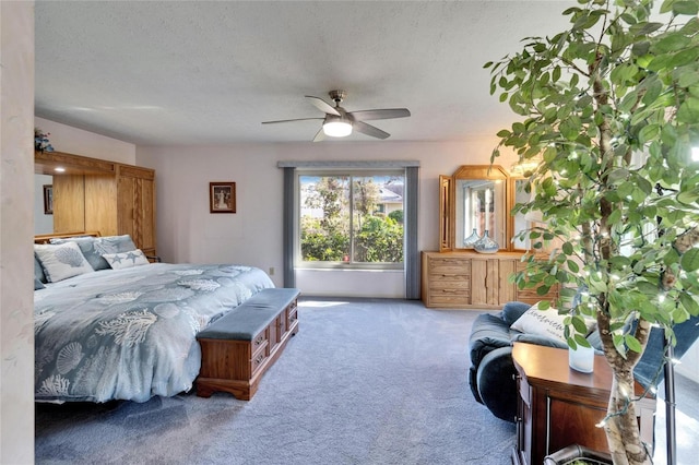 carpeted bedroom with a ceiling fan and a textured ceiling