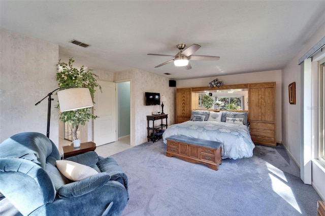 bedroom featuring light colored carpet, visible vents, and ceiling fan