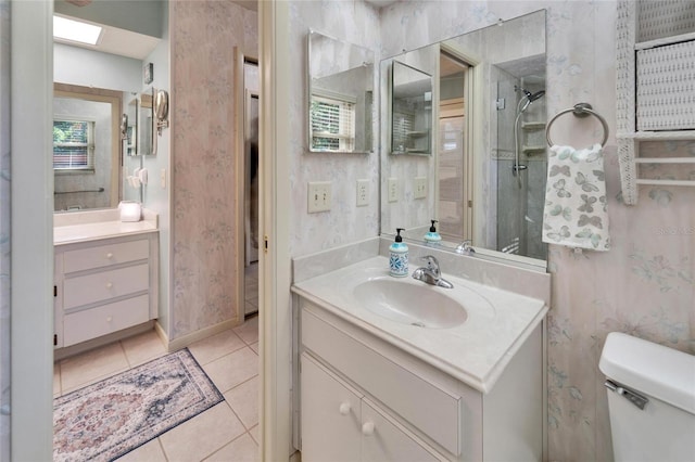 full bath featuring vanity, tile patterned flooring, and wallpapered walls