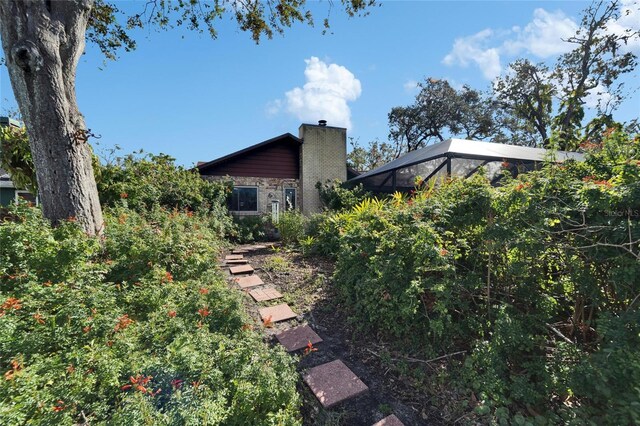 view of yard featuring glass enclosure