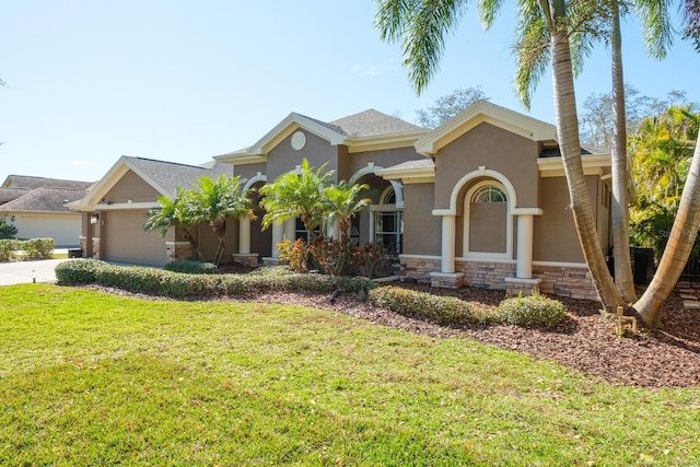 view of front of property with a garage and a front lawn