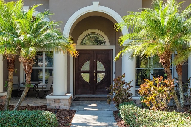 view of exterior entry with a porch