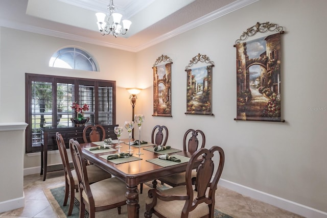 tiled dining space with an inviting chandelier, a tray ceiling, and ornamental molding