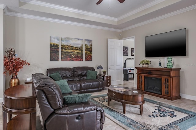 living room featuring ornamental molding, light tile patterned floors, ceiling fan, and a tray ceiling