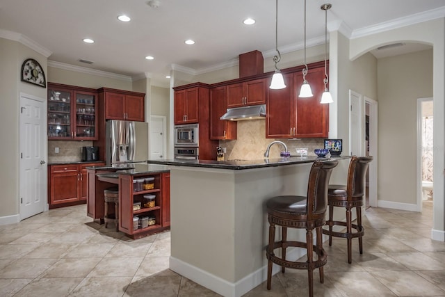 kitchen featuring a kitchen island, appliances with stainless steel finishes, pendant lighting, backsplash, and ornamental molding