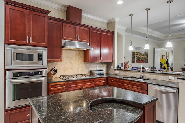 kitchen with sink, appliances with stainless steel finishes, tasteful backsplash, decorative light fixtures, and dark stone counters