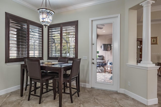 dining space with crown molding, light tile patterned flooring, decorative columns, and a notable chandelier