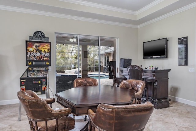 tiled dining area with crown molding, a raised ceiling, and ceiling fan