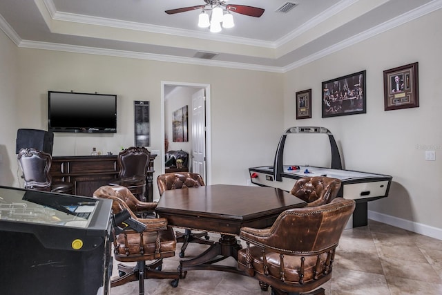 tiled office featuring ornamental molding, ceiling fan, and a tray ceiling