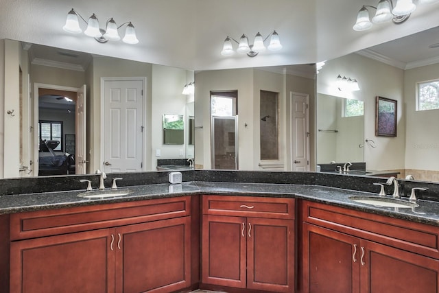 bathroom with vanity, crown molding, and walk in shower