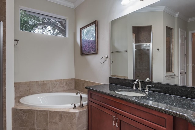 bathroom with crown molding, vanity, and shower with separate bathtub