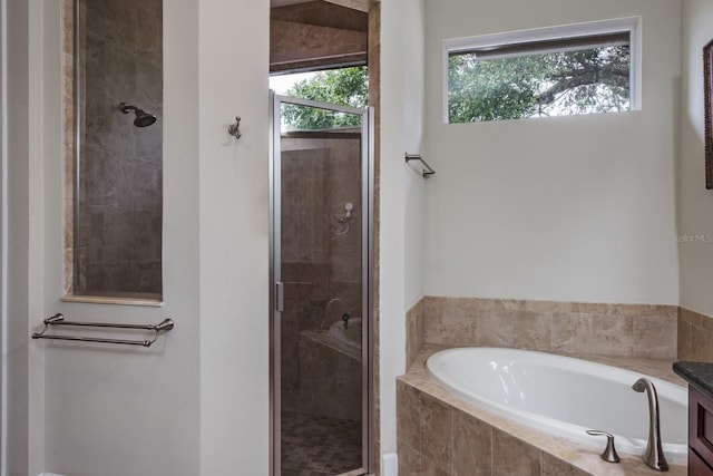 bathroom with independent shower and bath and vanity