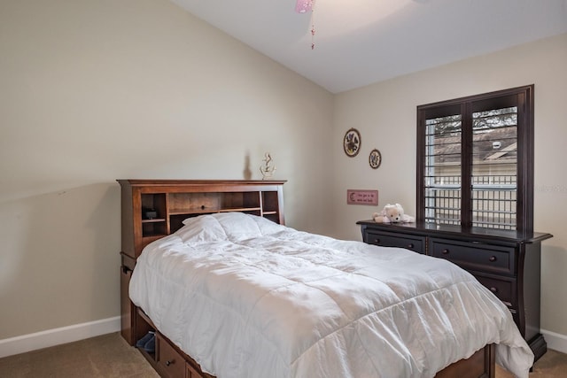 carpeted bedroom with lofted ceiling