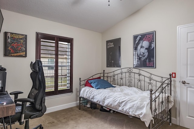 carpeted bedroom featuring lofted ceiling and a textured ceiling