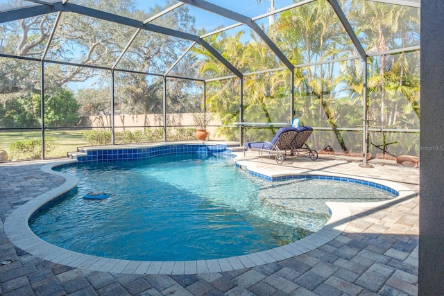 view of pool featuring a patio and glass enclosure