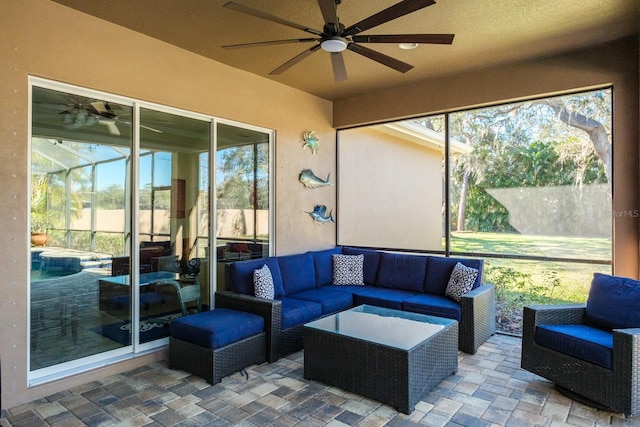 sunroom featuring plenty of natural light and ceiling fan