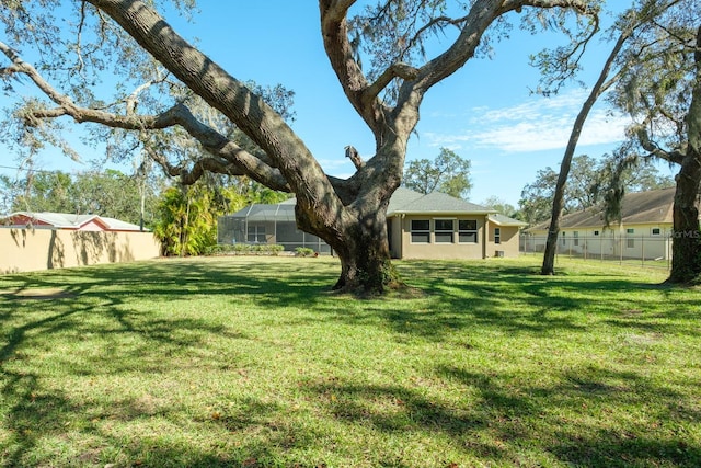 view of yard featuring glass enclosure