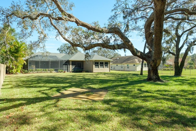 view of yard with glass enclosure