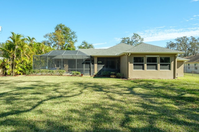 back of property featuring a lanai and a lawn