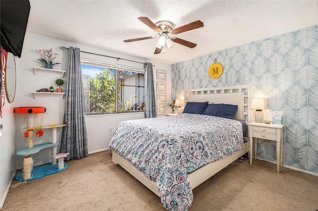 carpeted bedroom with ceiling fan and a textured ceiling