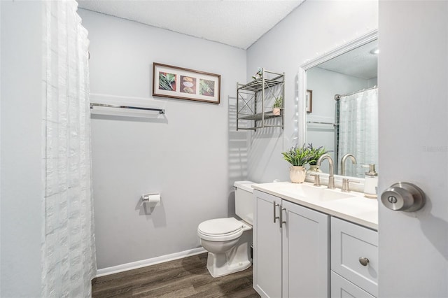 bathroom with vanity, wood-type flooring, and toilet