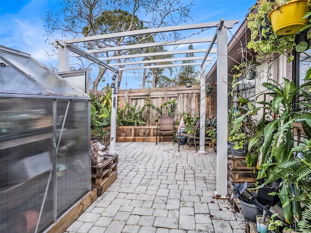 view of patio with a pergola and an outdoor structure