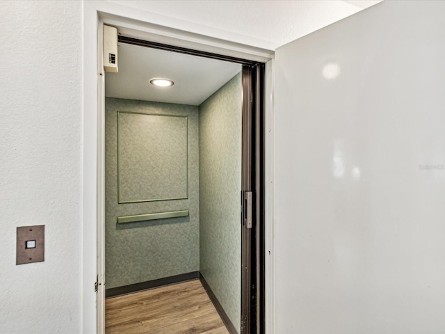 interior space featuring hardwood / wood-style flooring and elevator