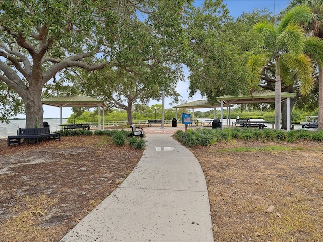 surrounding community with a gazebo and a water view